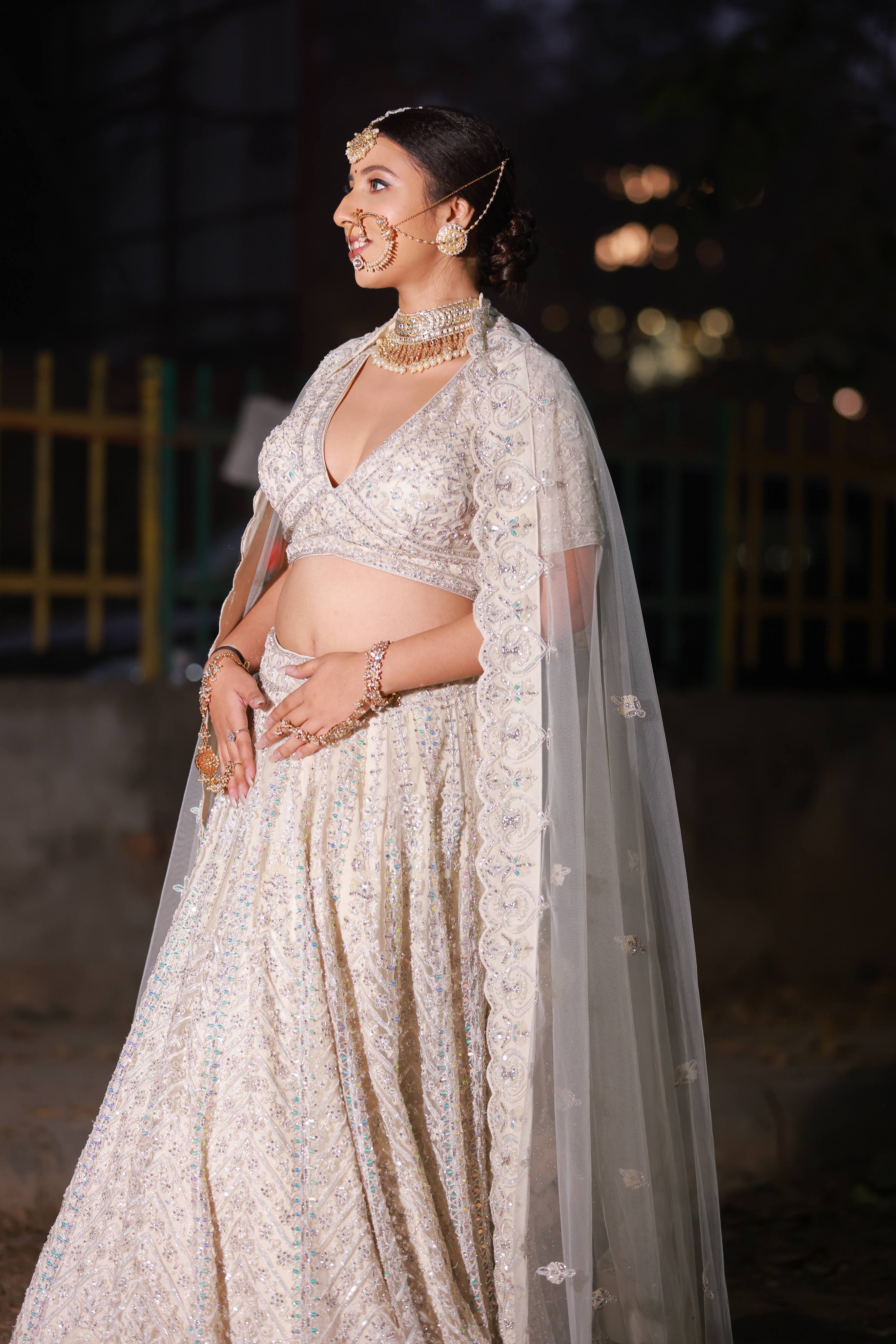 Ethereal Ivory Pearl Embroidered Bridal Lehenga with Cape Sleeves and Sheer Dupatta
