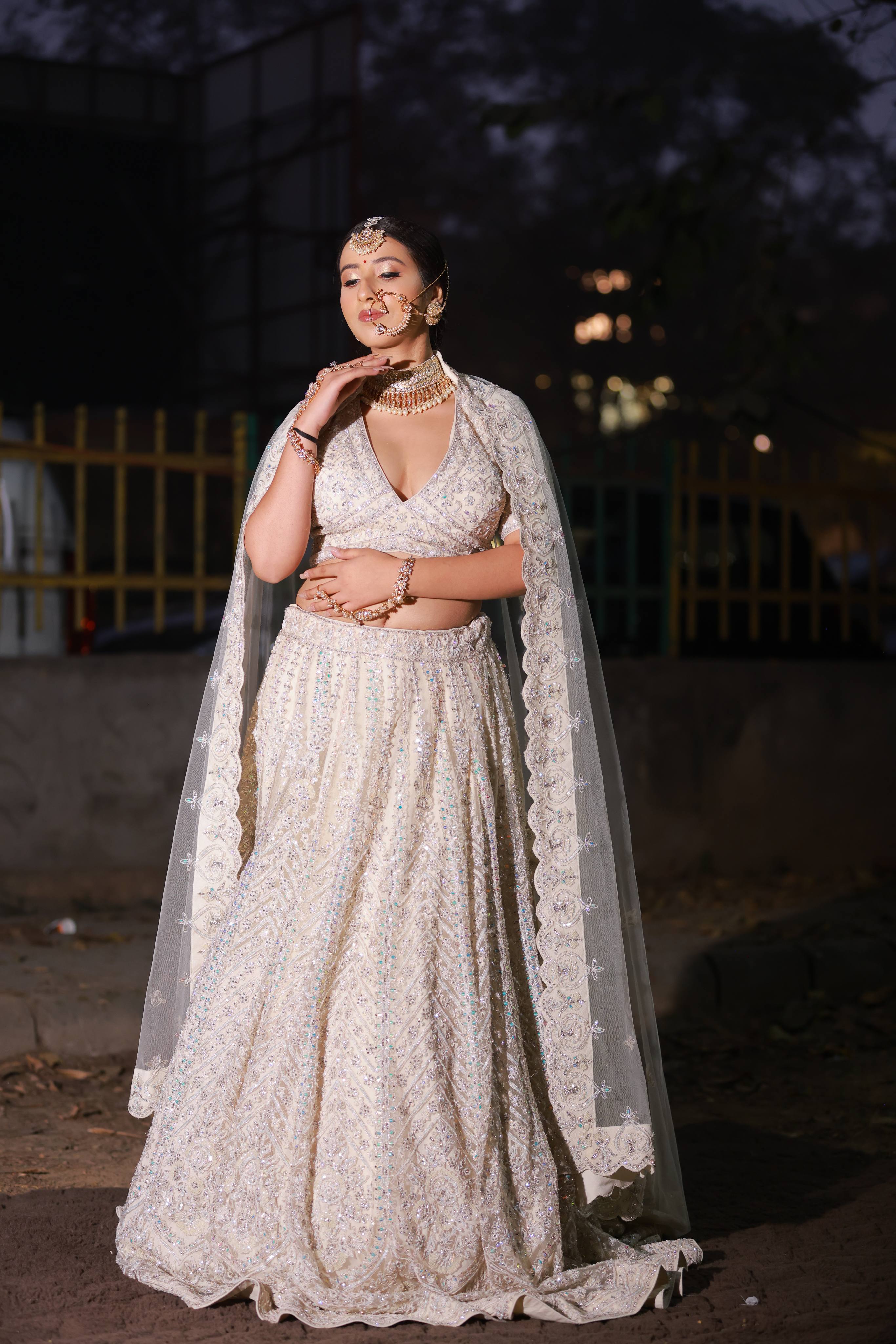 Ethereal Ivory Pearl Embroidered Bridal Lehenga with Cape Sleeves and Sheer Dupatta