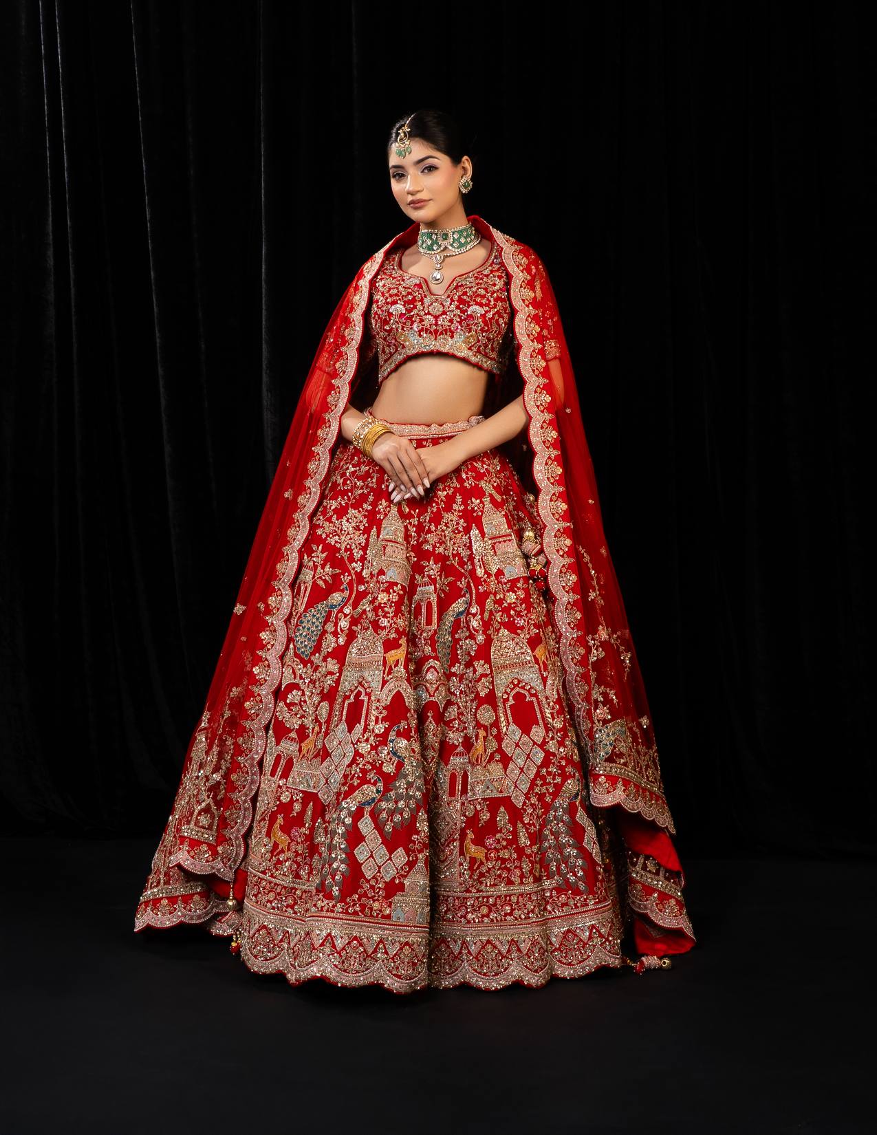 Regal Red Bridal Lehenga with Majestic Peacock and Jharokha Motifs in Golden Embroidery