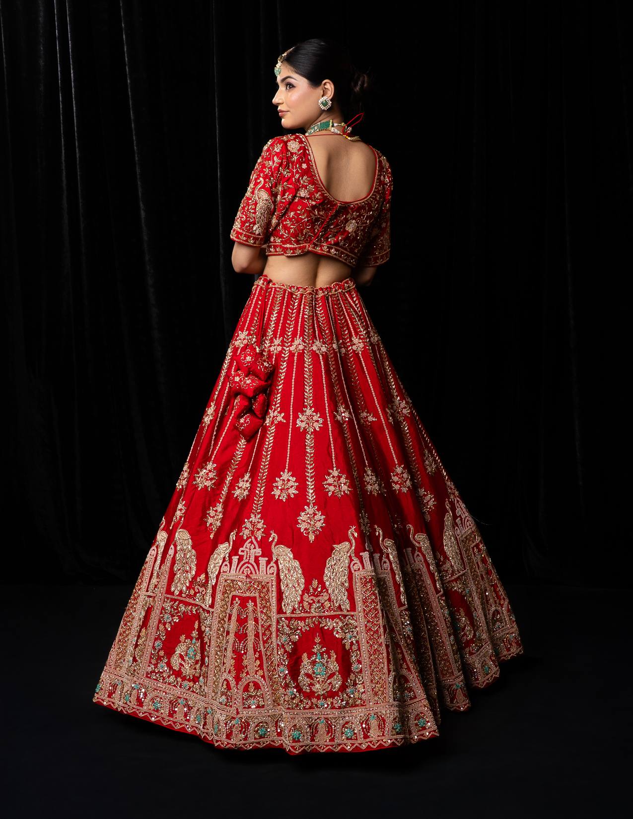 Luxurious Crimson Red Bridal Lehenga with Golden Jharokha and Peacock Embroidery